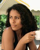 Woman sitting with a cup after Nose Surgery